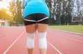 Woman runner suffering from pain in legs be injured,Hand touching her knee after jogging on track running Royalty Free Stock Photo