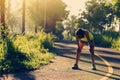 Woman runner take a break at morning tropical forest trail Royalty Free Stock Photo