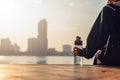 Woman runner takes a break after jogging in the morining.