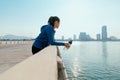 Woman runner takes a break after jogging in the morining