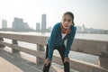 Woman runner takes a break after jogging in the morining