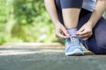 Woman runner typing shoelace wearing shoes getting ready for running Royalty Free Stock Photo