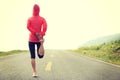 Woman runner warm up on country road Royalty Free Stock Photo