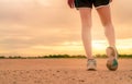 Woman runner wear sport shoes and warming up before run at the park in the morning. Asian female cardio exercise for healthy life. Royalty Free Stock Photo