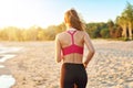 Woman running alone at beautiful dusk on the beach