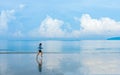 Woman running along the beach of the sea with beautiful sky and blue sea background, healthy lifestyle outdoor exercise concept Royalty Free Stock Photo