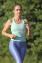 Woman running along the road in the forest Royalty Free Stock Photo