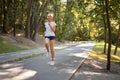 Woman running asphalt road summer park Royalty Free Stock Photo