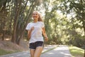 Woman running asphalt road summer park Royalty Free Stock Photo