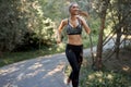 Woman running asphalt road summer park Royalty Free Stock Photo