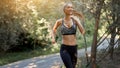 Woman running asphalt road summer park Royalty Free Stock Photo