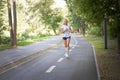 Woman running asphalt road summer park Royalty Free Stock Photo