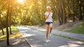 Woman running asphalt road summer park Royalty Free Stock Photo