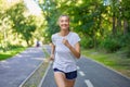 Woman running asphalt road summer park Royalty Free Stock Photo