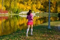 Woman running in autumn park, beautiful girl runner jogging outdoors Royalty Free Stock Photo