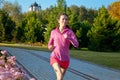 Woman running in autumn park, beautiful girl runner jogging outdoors Royalty Free Stock Photo