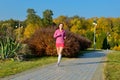 Woman running in autumn park, beautiful girl runner jogging outdoors Royalty Free Stock Photo