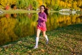 Woman running in autumn park, beautiful girl runner jogging outdoors Royalty Free Stock Photo