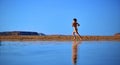 Woman running on the beach Royalty Free Stock Photo