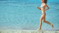 Woman running on the beach Royalty Free Stock Photo