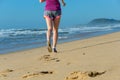 Woman running on beach, girl runner jogging outdoors Royalty Free Stock Photo