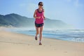 Woman running on beach, girl runner jogging outdoors Royalty Free Stock Photo