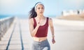 Woman running at beach promenade for fitness, energy and strong summer body. Female runner, sports person and athlete at Royalty Free Stock Photo