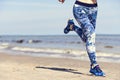 Woman running on the beach, space for copy