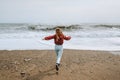 Woman running on beach stormy sea landscape Royalty Free Stock Photo