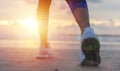 Woman running on the beach at sunrise closeup on shoe. Patong be Royalty Free Stock Photo