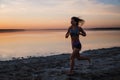 Woman Running on the Beach at Sunset Royalty Free Stock Photo
