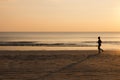 Woman running on the beach at sunset, healthy lifestyle Royalty Free Stock Photo