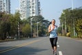Woman running at city street Royalty Free Stock Photo