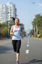 Woman running at city street Royalty Free Stock Photo