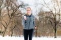 Woman running down a path on winter day in park Royalty Free Stock Photo