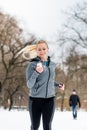 Woman running down a path on winter day in park Royalty Free Stock Photo