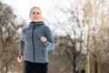 Woman running down a path on winter day in park Royalty Free Stock Photo