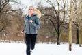 Woman running down a path on winter day in park Royalty Free Stock Photo