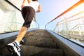 Woman running on escalator stairs Royalty Free Stock Photo