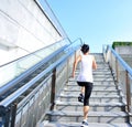 Woman running on escalator stairs Royalty Free Stock Photo