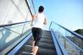 Woman running on escalator stairs Royalty Free Stock Photo