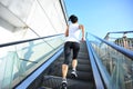 Woman running on escalator stairs Royalty Free Stock Photo