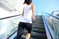 Woman running on escalator stairs Royalty Free Stock Photo