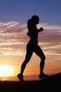 Woman running, fitness on beach and sunset for workout, outdoor training and body health in shadow or a silhouette Royalty Free Stock Photo