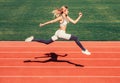 Woman running jump on stadium track. Sportswoman in sportswear jumping. Woman running during. Sport backgrounds. Runner Royalty Free Stock Photo