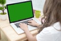 Woman with running in the laptop. Green screen background.