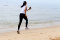 Woman running morning with spot cloth on beach