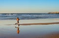 Woman running ocean beach sunset