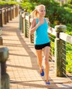 Woman running outside along path Royalty Free Stock Photo