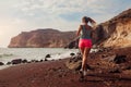 Woman running on Red beach on Santorini island. Female runner jogging during outdoor workout enjoying view Royalty Free Stock Photo